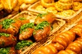 Mix of different fresh baking, pastry, small pie at the shelfs of bakery Royalty Free Stock Photo