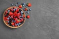 Mix of different fresh berries in bowl on table, flat lay. Space for text Royalty Free Stock Photo