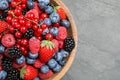 Mix of different fresh berries in bowl on table, top view. Space for text Royalty Free Stock Photo