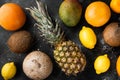 Mix of different fruits, on black dark stone table background, top view flat lay Royalty Free Stock Photo