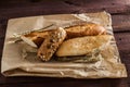 Mix of different varieties of bread lying on a wooden table Royalty Free Stock Photo