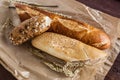 Mix of different varieties of bread lying on a wooden table Royalty Free Stock Photo