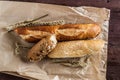 Mix of different varieties of bread lying on a wooden table Royalty Free Stock Photo