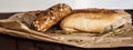 Mix of different varieties of bread lying on a wooden table Royalty Free Stock Photo