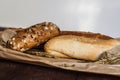 Mix of different varieties of bread lying on a wooden table Royalty Free Stock Photo