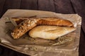 Mix of different varieties of bread lying on a wooden table Royalty Free Stock Photo