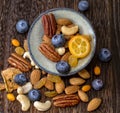 Mix dried fruit and nuts on a wooden background.