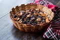 Mix of Dried Fruits; Apple, Apricot, Mulberry, Raisin, Fig, Cranberry, Raspberry and Date in Wooden Basket.