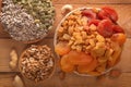 Mix of dried fruits, assorted nuts and seeds on a wooden table. Royalty Free Stock Photo