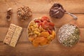 Mix of dried fruits, energy bites, chocolate paste, assorted nuts and seeds on a wooden table. Royalty Free Stock Photo