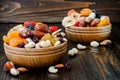 Mix of dried fruits and nuts on a dark wood background with copy space. Symbols of judaic holiday Tu Bishvat.