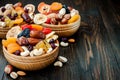 Mix of dried fruits and nuts on a dark wood background with copy space. Symbols of judaic holiday Tu Bishvat.