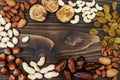 Mix of dried fruits and nuts on a dark wood background with copy space. Top view. Symbols of judaic holiday Tu Bishvat. Royalty Free Stock Photo