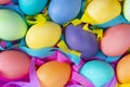 Mix of Easter bright dyed chicken eggs with colorful ribbons