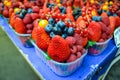 Mix of fresh berries in a baskets : strawberries, raspberries, blueberries sold on the market Royalty Free Stock Photo