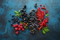 Mix of fresh berries with leaves on textured metal background Royalty Free Stock Photo