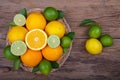 Mix of fresh citrus fruits in basket on wood Royalty Free Stock Photo