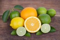 Mix of fresh citrus fruits in basket on wood Royalty Free Stock Photo