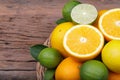 Mix of fresh citrus fruits in basket on wood Royalty Free Stock Photo