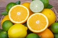 Mix of fresh citrus fruits in basket on wood Royalty Free Stock Photo