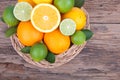 Mix of fresh citrus fruits in basket on wood Royalty Free Stock Photo