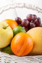 Mix of fresh fruits in the white bascket Royalty Free Stock Photo