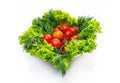 Mix of fresh vegetables - dill, tomatoes and green salad leaves. White background, isolated