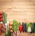 Mix of fresh vegetables on a wooden table. Healthy and dietetic food. Vegan and vegetarian. Two hands preparing the show