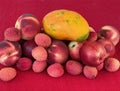 Mix fruit: fresh red peaches, nectarine. mango and lychee on red cloth napkin Royalty Free Stock Photo