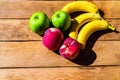 Mix of fruits on wooden table. Banana, apple, nectarine