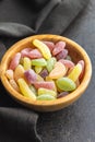 Mix of fruity jelly candy in wooden bowl