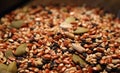 Mix of green sunflower seeds and black and brown sesame seeds with unfocused foreground and background. Royalty Free Stock Photo