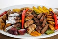 Mix grill family platter tikka kabab, lamb chop, meat kebab, chicken, beef, mutton, potato veggies, tomato and onion served in