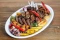 Mix grill family platter tikka kabab, lamb chop, meat kebab, chicken, beef, mutton, potato veggies, tomato and onion served in