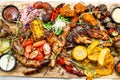 The mix of grilled meat and vegetables. Plate of mixed meat