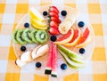 Mix of healthy fruits already cutted full of vitamins. Ready to eat. Colors of nature. Checkered tablecloth Royalty Free Stock Photo