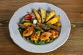 Mix kofta and shish tawook kabab with potato veggies, tomato, onion and coriander served in dish isolated on table side view of Royalty Free Stock Photo