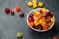 A mix of Midget Gems candy in white bowl. sweet food