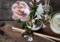 Mix of natural flowers and pink fabric flower on a rustic table. Scenital photo