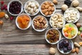 Mix of nuts and dried fruits in small bowls on wooden boards. Healthy and tasty snack Royalty Free Stock Photo