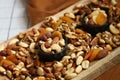 Mix of nuts and dried fruits on a wooden board and in a bowl. Healthy sweets Royalty Free Stock Photo