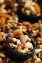 Mix of nuts and dried fruits on a wooden board and in a bowl. Healthy sweets Royalty Free Stock Photo
