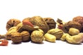 A mix of nuts on a white background. Walnuts, cashews, peanuts.