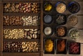 Mix of nuts in a wooden box and spices in bowls Royalty Free Stock Photo