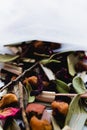 Mix of organic, natural Dry tea beverage in filter teabag sachet closeup. Leaves, fruits, berries, flowers healthy drink