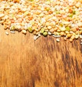 Colorful mixed cereals and legumes: rice, peas, lentils and pearl barley on a wooden background. View from above. Empty space for Royalty Free Stock Photo