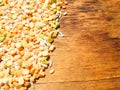 Colorful mixed cereals and legumes: rice, peas, lentils and pearl barley on a wooden background. View from above. Empty space for Royalty Free Stock Photo