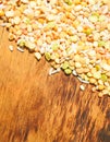 Colorful mixed cereals and legumes: rice, peas, lentils and pearl barley on a wooden background. View from above. Empty space for Royalty Free Stock Photo