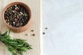 Mix peppercorns black, white, red and allspice in a wooden pestle with a chime for a mortar on a wooden background. Royalty Free Stock Photo