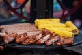 Mix of Rack of pork ribs, Beef sausages and corn on the cobs on the grill Royalty Free Stock Photo